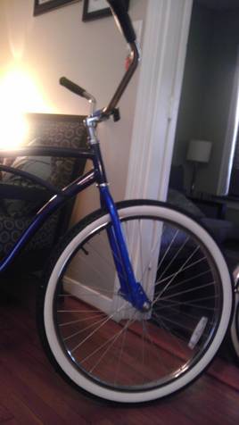 1953 Ford Mainline - A blue bicycle with whitewall tires and chrome handlebars is shown indoors.