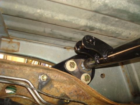 1995 Ford Bronco - Custom rear axle shock mount assembly with visible bolts and bracketry.
