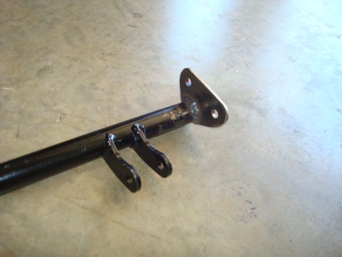 1995 Ford Bronco - A close-up view of a custom rear shock hoop bracket with welded tabs and mounting holes.