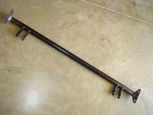 Black metal bar with mounting flanges and brackets