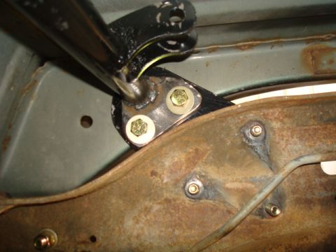 1995 Ford Bronco - Close-up of a rear shock hoop mount attached to a vehicle's frame.
