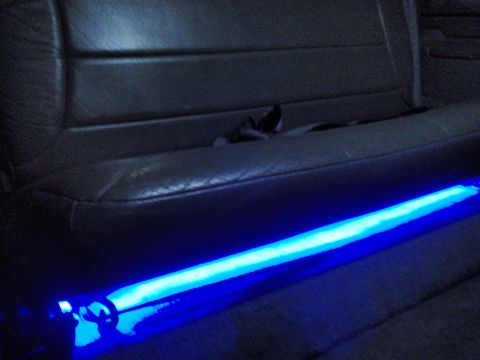 1995 Ford Bronco - Blue LED strip lighting is installed under the seat of the vehicle's interior.