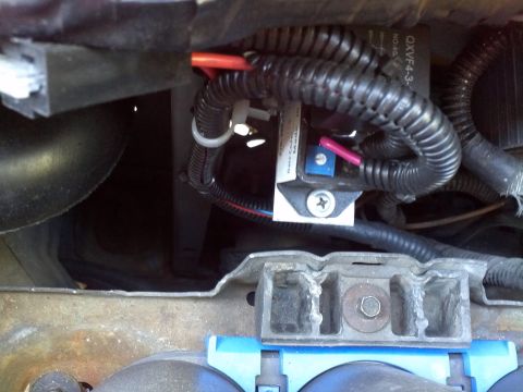 1993 Ford Bronco - A close-up view of an automotive electrical relay and its wiring harness, showing a part number on the relay.