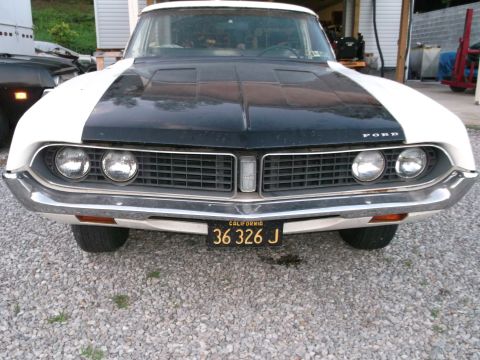 1971 Ford Ranchero - This 1971 Ford Ranchero features a distinctive two-tone paint scheme with a black hood and white body.