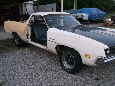 1971 Ford Ranchero - Ford Ranchero in primer and white paint, driver door ajar. Another vehicle is covered in the background.