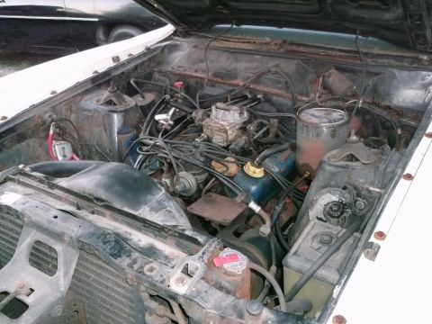 1971 Ford Ranchero - Engine bay view showing the V8 engine and its components. A paint can is visible on the right side.