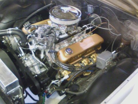 1965 Ford Galaxie - Close-up view of a V8 engine, likely modified, with custom valve covers and air intake.