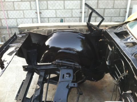 1967 Pontiac Grand Prix - The chassis and wheel well of a vehicle are visible, painted black.