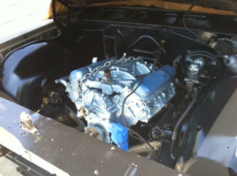 1967 Pontiac Grand Prix - Engine bay view showing a V8 engine with a chain hoist sling, ready for installation or maintenance.