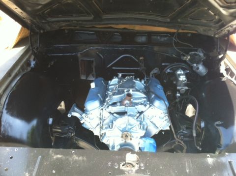 1967 Pontiac Grand Prix - The engine bay of a car, showing a V8 engine that has been recently installed or rebuilt.