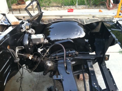 1967 Pontiac Grand Prix - The chassis of a 1967 Pontiac Grand Prix is shown from the front, with engine components visible.