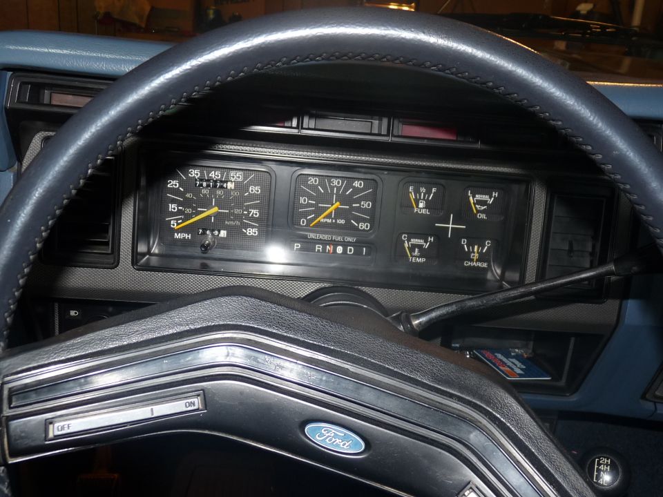 1986 Ford Bronco interior dashboard with speedometer, tachometer, fuel, oil, temp, and charge gauges