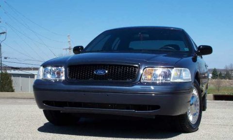 1998 Ford Crown Victoria - Front view of a dark blue 1998 Ford Crown Victoria parked outside.