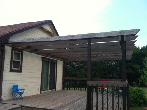 1994 Ford Bronco - A view of a wooden deck and house, a pergola and outdoor seating.
