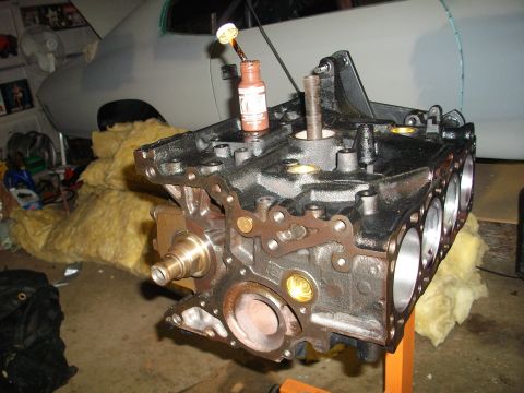 1989 Ford Probe - Engine block assembly in progress, with a bottle of sealant perched on top.