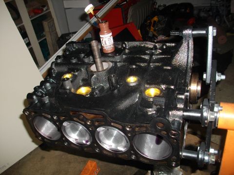 1989 Ford Probe - Engine block with pistons is ready for assembly on an engine stand.