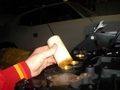 1989 Ford Probe - Mechanic installs a part into a car engine, with a wrench visible in the background.