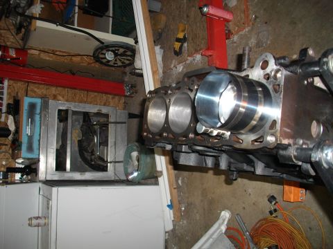 1989 Ford Probe - Engine block with cylinders is shown in a garage setting, possibly during a rebuild.