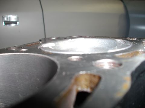 1989 Ford Probe - A close-up view of an engine's cylinder head, with a portion of a vehicle's interior visible in the background.
