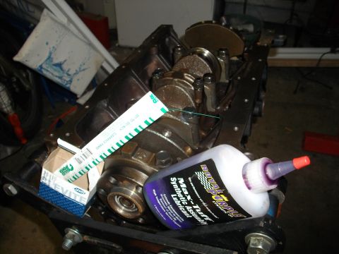 1989 Ford Probe - Engine block components are laid out with assembly lubricant and feeler gauges for a project.