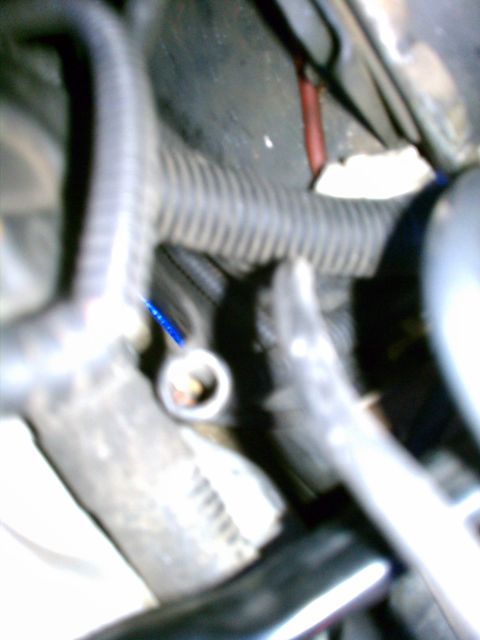 1993 Ford Bronco - A view of the complex wiring and hoses within a vehicle's engine compartment.
