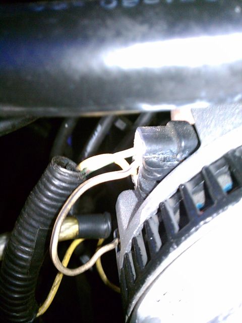 1993 Ford Bronco - Close-up view of alternator wiring and connections within an engine bay.