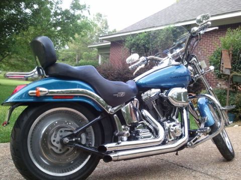 1967 Ford Mustang - This is a blue Harley-Davidson motorcycle with chrome details and a black seat, seen from the side.