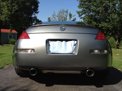 1996 Ford Bronco - The rear of a gray Nissan 350Z is shown with its distinctive taillights and spoiler.