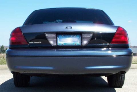 1998 Ford Crown Victoria - The rear of a Ford Crown Victoria Police Interceptor is shown under a clear blue sky.