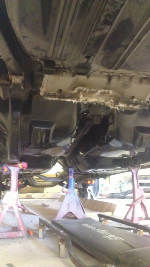 1970 Chevrolet Camaro - The underside of a vehicle is visible, showing areas of rust and repair work.