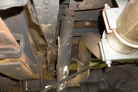1987 Ford F-250 - Undercarriage of a 1987 Ford F-250, focusing on suspension and exhaust components.