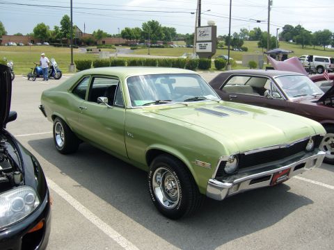 2007 Ford Mustang - Light green 1970 Chevrolet Nova with black hood stripes and chrome wheels.
