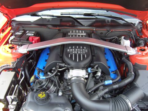 2007 Ford Mustang - The engine bay of a Ford Mustang, identified as a 2011 model based on its distinctive "BOSS 302" badging and engine design.