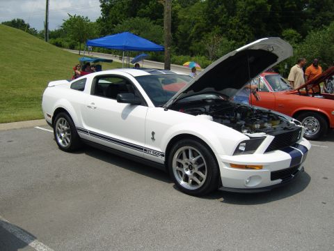 2007 Ford Mustang - White 2007 Ford Mustang GT 500 at River Church Show, hood up to display engine.
