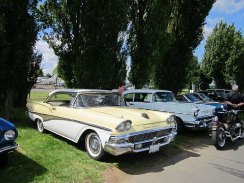 1991 Ford LTD Crown Victoria - Several classic vehicles, including a 1958 Ford Fairlane 500, are displayed outdoors on a sunny day.