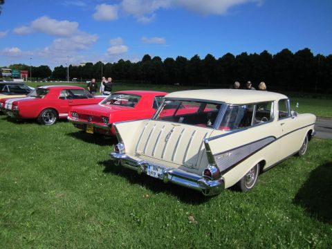 1991 Ford LTD Crown Victoria - A cream-colored 1957 Chevrolet Nomad station wagon is parked on grass with other vintage cars.