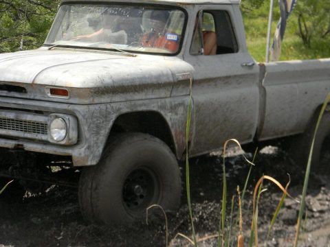 1989 Ford Bronco - This classic 1966 Chevrolet C10 pickup truck navigates through a muddy terrain, its off-road capabilities.