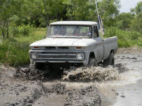 1989 Ford Bronco - This vintage Chevrolet C10 navigates a muddy off-road trail.
