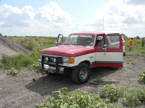 1989 Ford Bronco - This 1989 Ford Bronco is parked outdoors with its doors open, showing off its two-tone paint scheme.