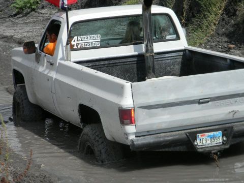 1989 Ford Bronco - This lifted pickup truck navigates through a muddy off-road course, its off-road capabilities.
