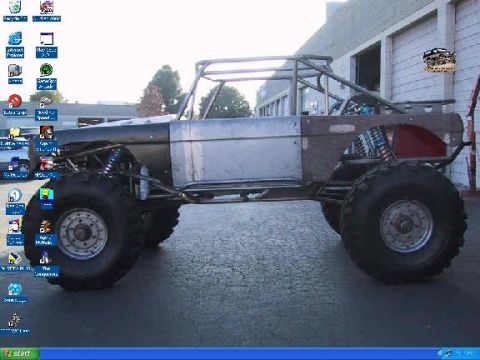 1989 Ford Bronco - This heavily modified 1989 Ford Bronco features an exposed chassis, custom roll cage, and oversized off-road tires.