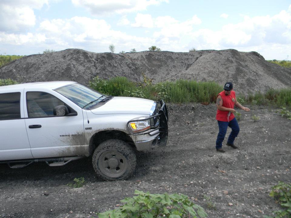 White pickup truck with bull bar on a dirt road