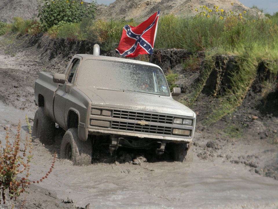 Mud-covered pickup truck with Confederate flag, 1985 grille