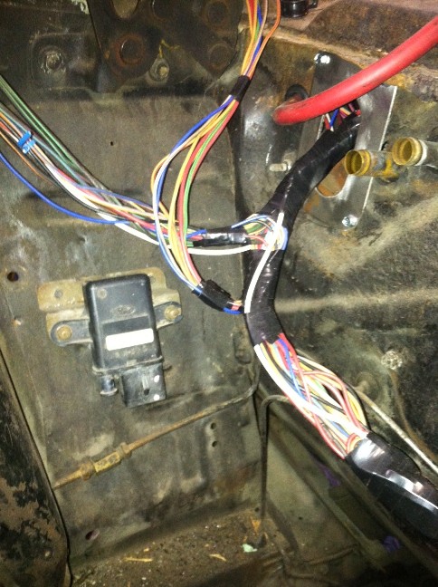 Vehicle firewall with multicolored wiring harness and relay during rewire