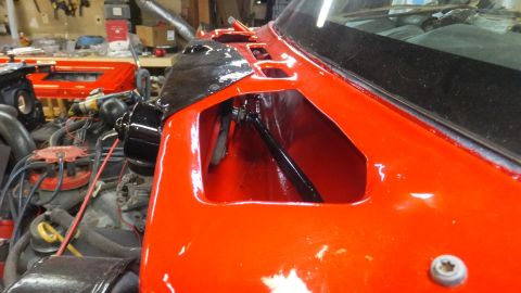 1983 Ford Bronco - Close-up view of an orange vehicle's fender, revealing the engine and interior components. The Supermotors.net logo is present in the lower…