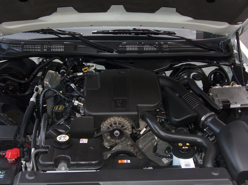 2006 Ford Crown Victoria engine bay with V8 engine, alternator, and coolant reservoir