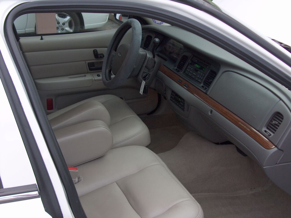 Interior of a 2006 Ford Crown Victoria with tan leather seats and wood trim