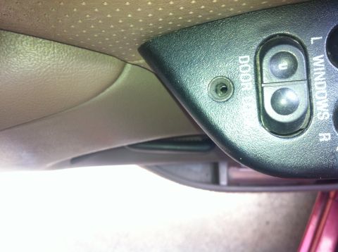 1996 Ford Bronco - Close-up of the interior door panel showing the window lock and controls for the left and right windows.