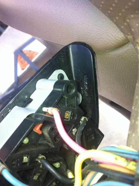 1996 Ford Bronco - A close-up view of a vehicle's interior wiring harness, showing electrical components and wires.