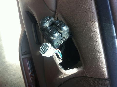 1996 Ford Bronco - Interior view of a disconnected power window switch assembly, showing the wiring harness.
